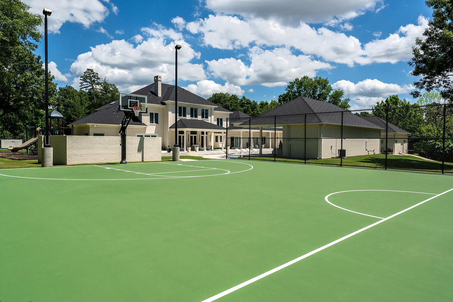 Outdoor basketball court at The Thornwood with modern residential homes nearby.