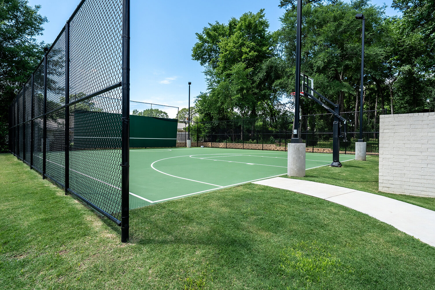 Basketball court with fencing and trees at The Thornwood.