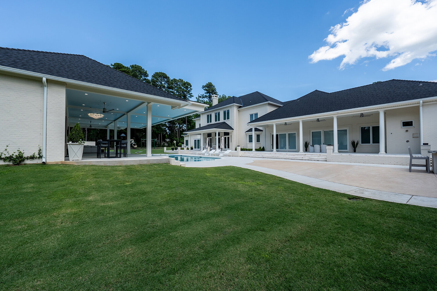 Modern luxury home with pool and spacious backyard.