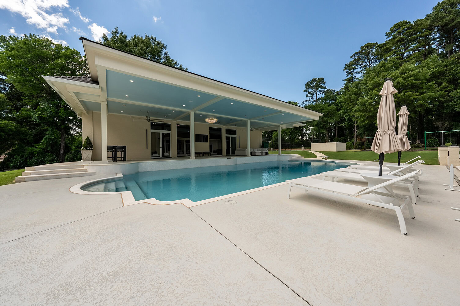 Contemporary pool house with a sleek design and outdoor pool at The Thornwood.