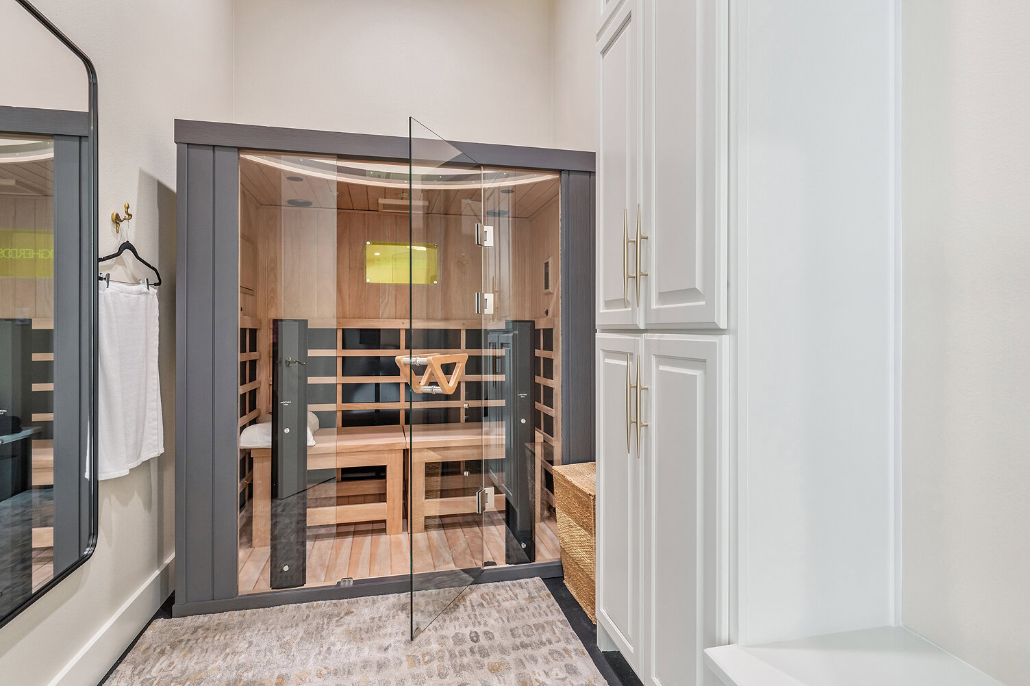 Modern indoor sauna with glass door and wooden interior design.