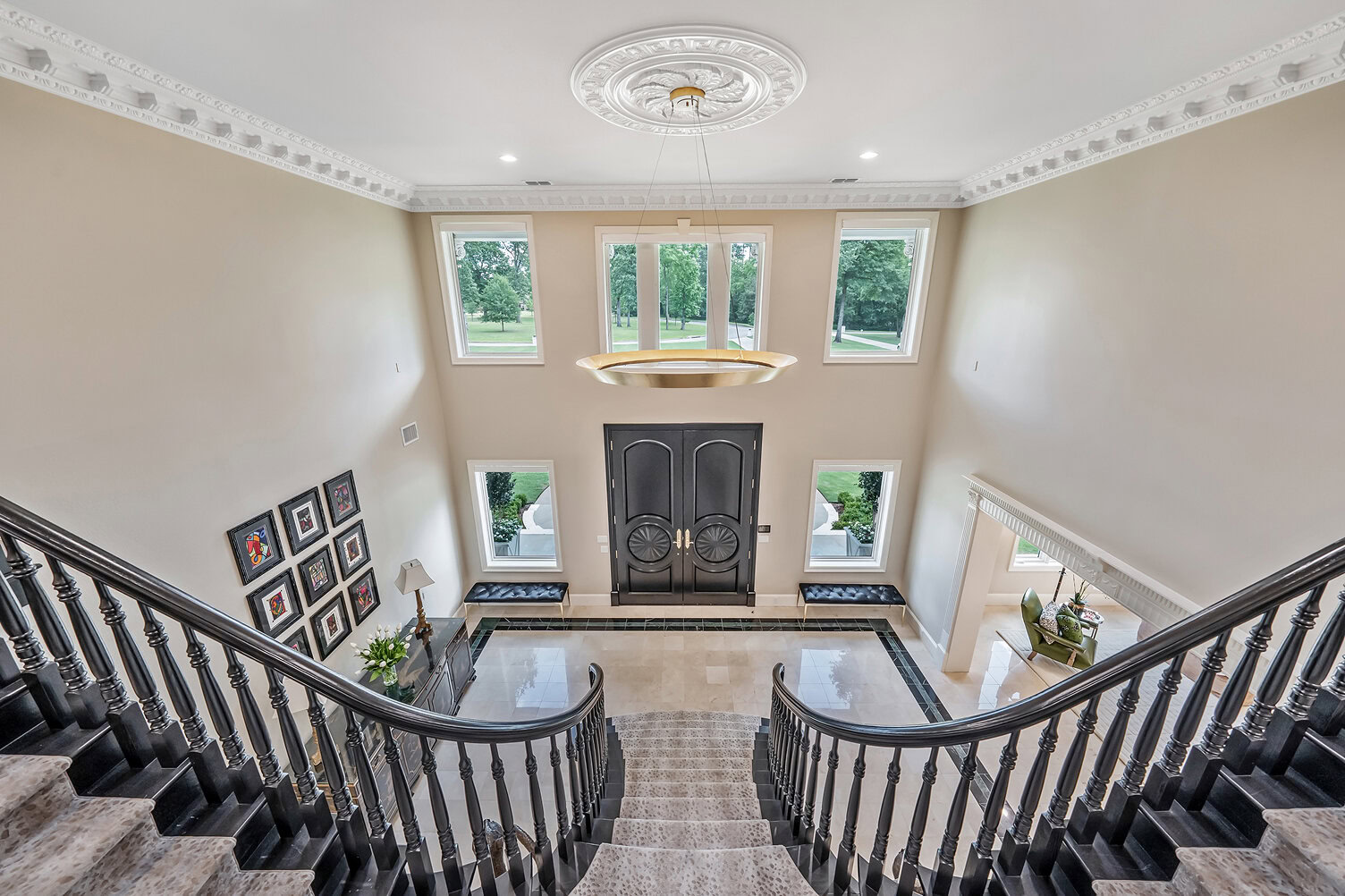 Spacious grand entrance with double doors and large windows.
