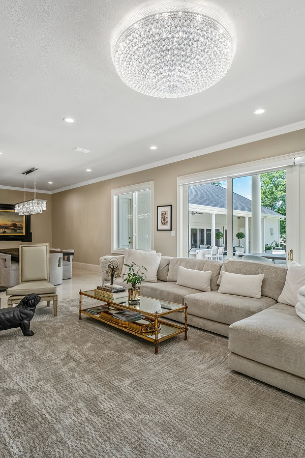 Bright and spacious living room with large windows and modern decor.