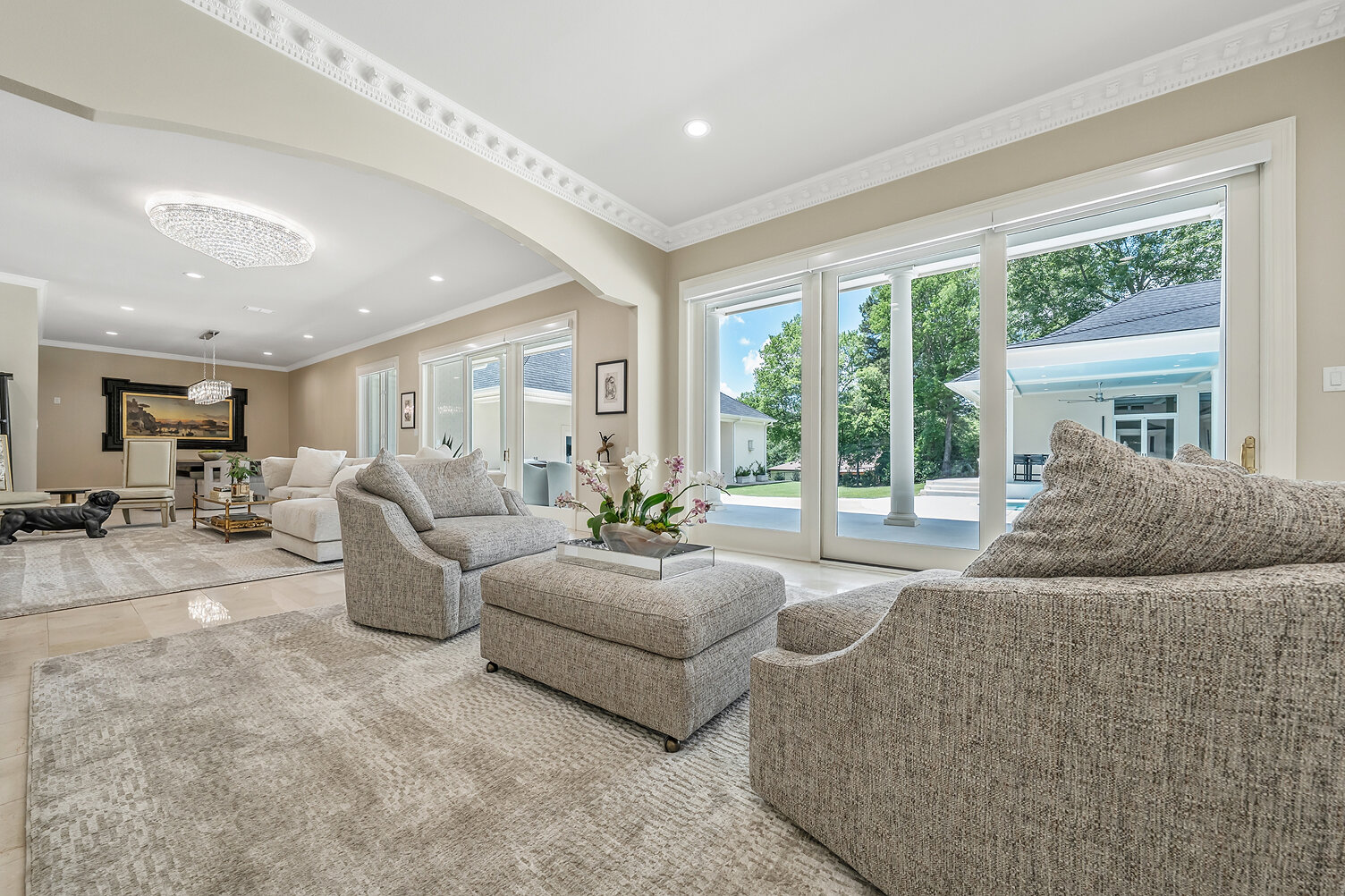 Bright and airy living room with large windows and modern furniture.