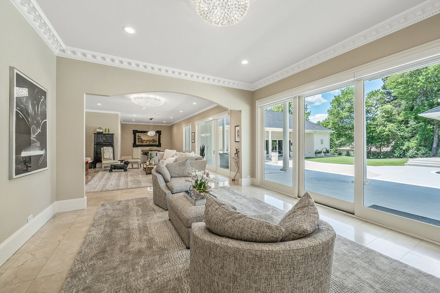 Bright, modern living room with large windows and elegant decor.