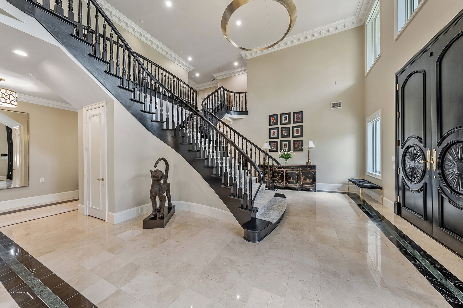 Spacious foyer with grand staircase and modern decor in The Thornwood.