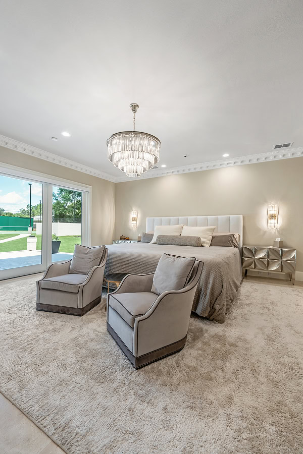 Luxurious bedroom with modern decor and large window in The Thornwood.