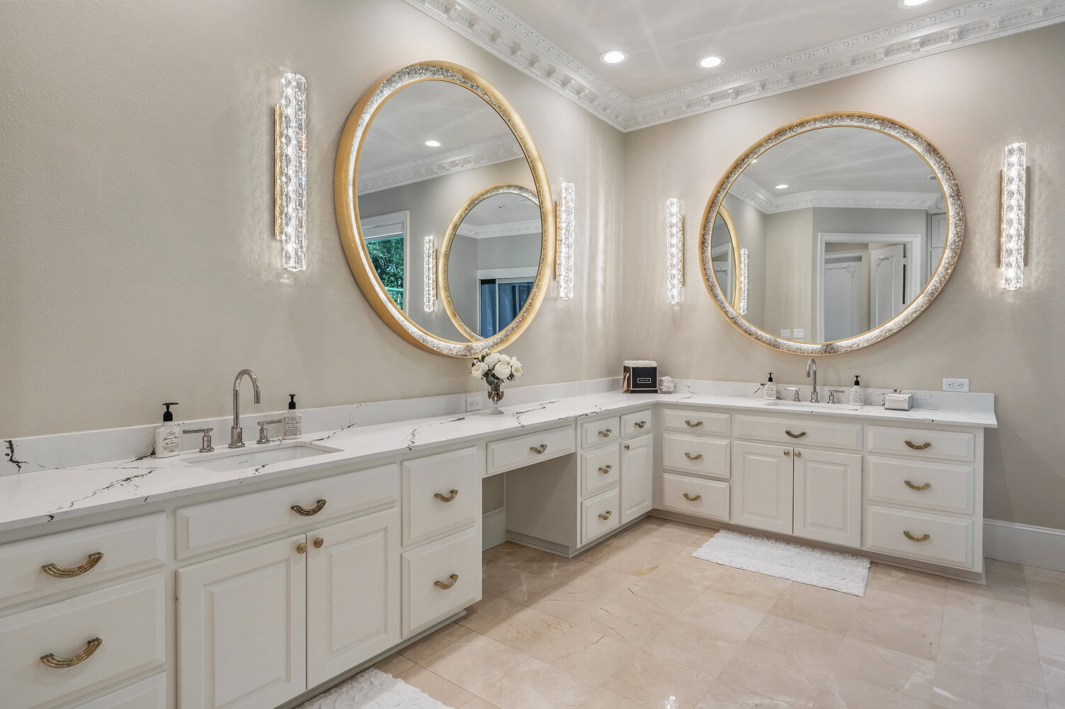 Luxurious bathroom with dual mirrors and white cabinetry.